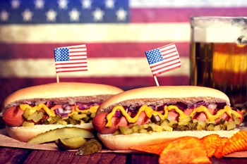 Hot dogs with American flag toothpicks.
