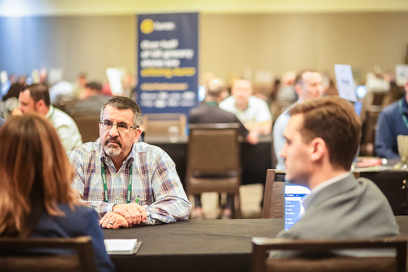 Several people in a b2b meeting at the FMI APGR conference