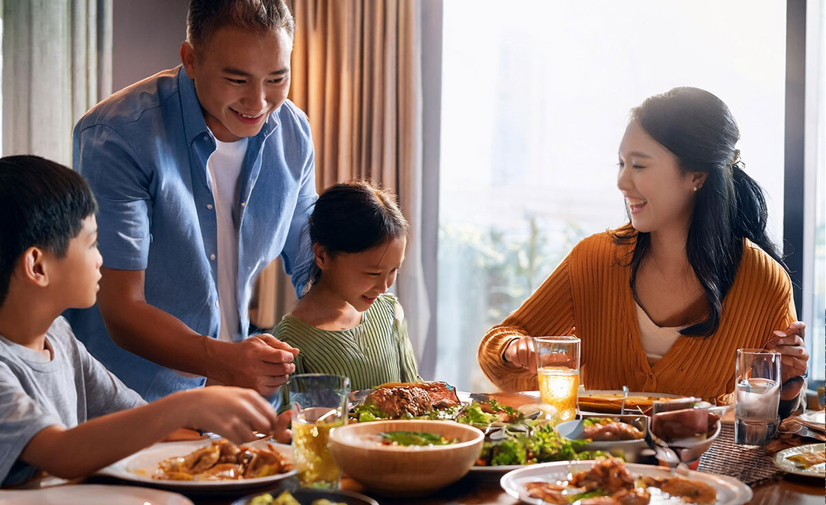 Smiling family around dinner table