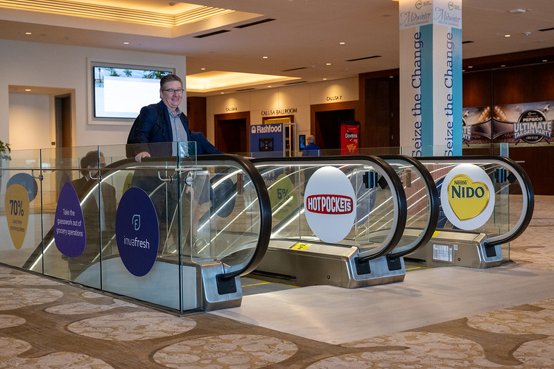 Sponsor logos on escalators at Midwinter 2025